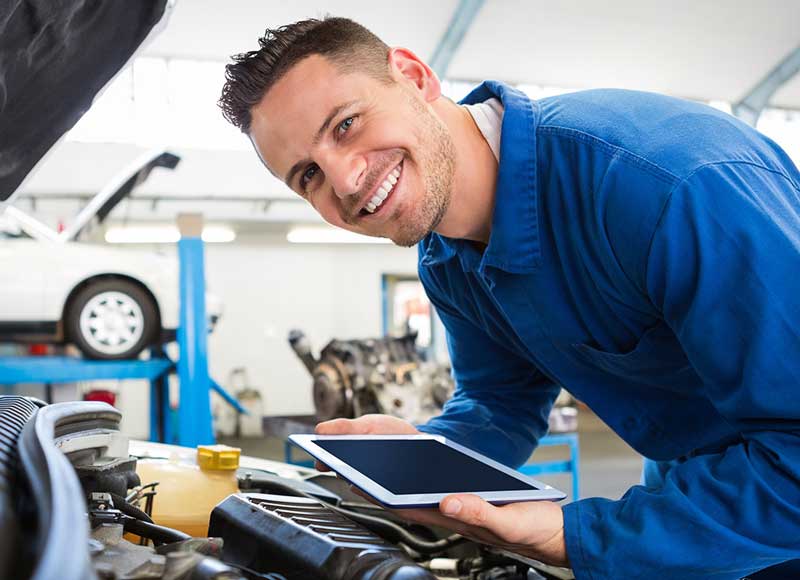 service tech with tablet Kia Of Fargo in Fargo ND
